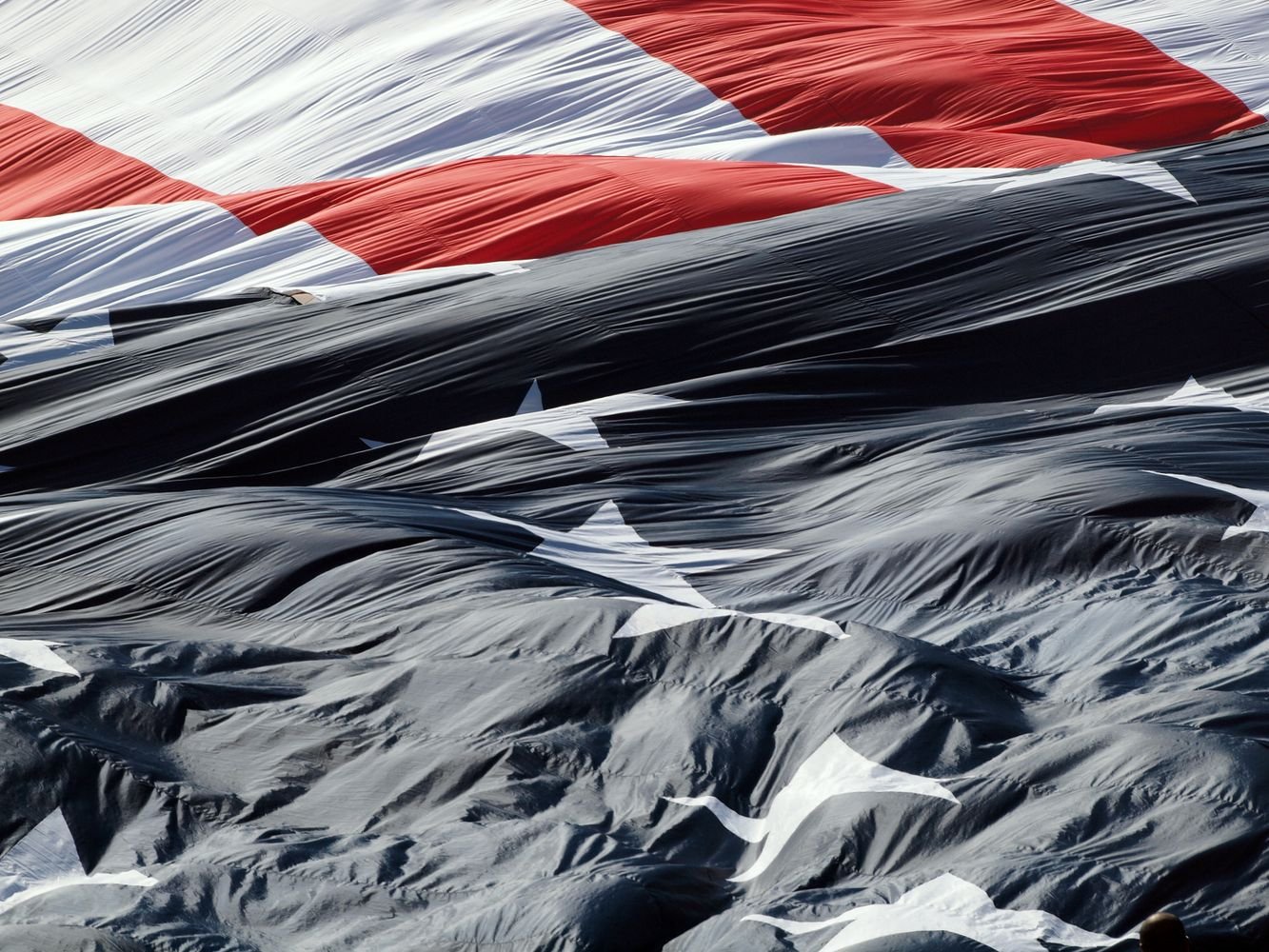 A close-up of the American flag, representing the flag folded and presented by an Honor Guard