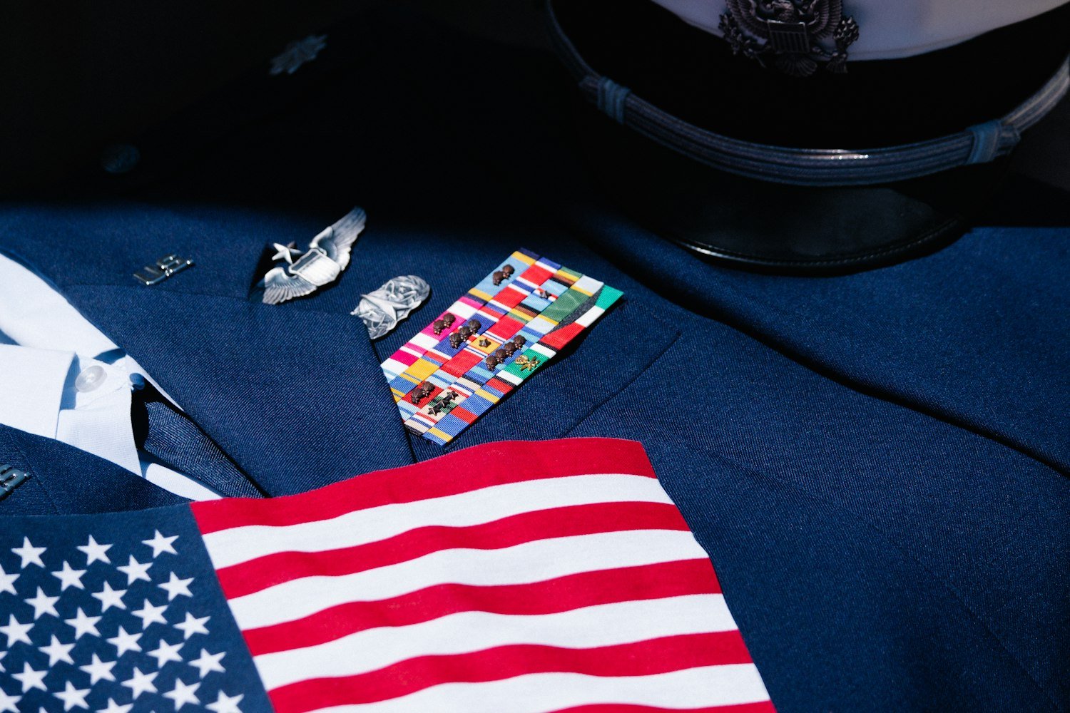 An American flag pin on a suit lapel, representing a military retiree
