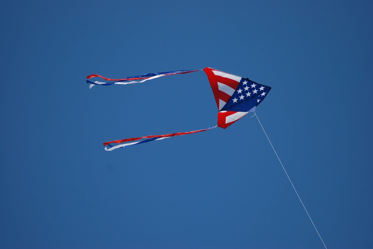 An American flag flying on a pole during the daytime