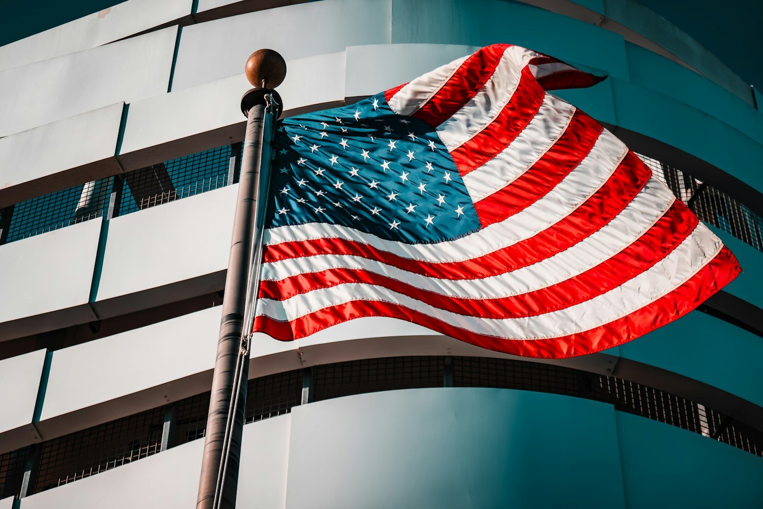 An American flag waving outside a community building, reflecting the patriotic spirit of American Legion posts