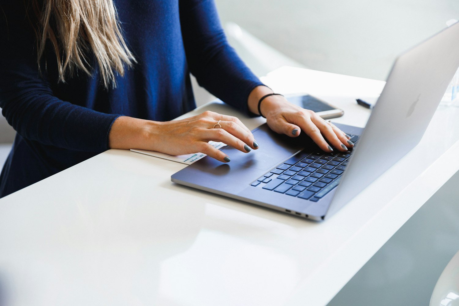 A person using a laptop to apply for jobs, as on the USAJOBS federal hiring site