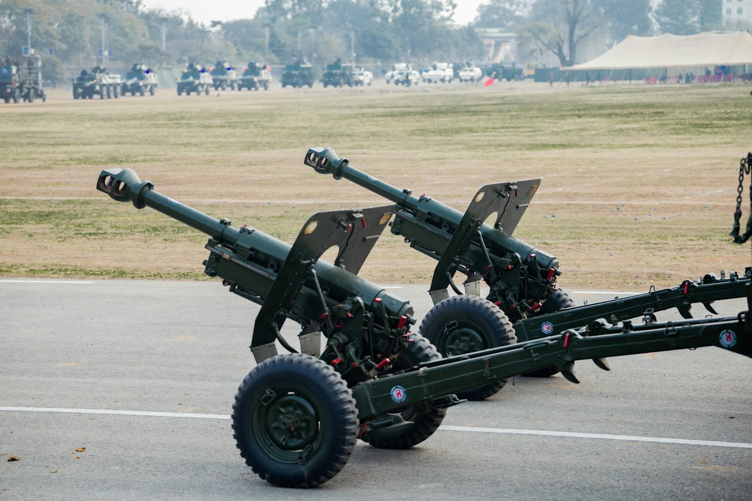 Two artillery cannons, representing the acoustic trauma common in combat arms