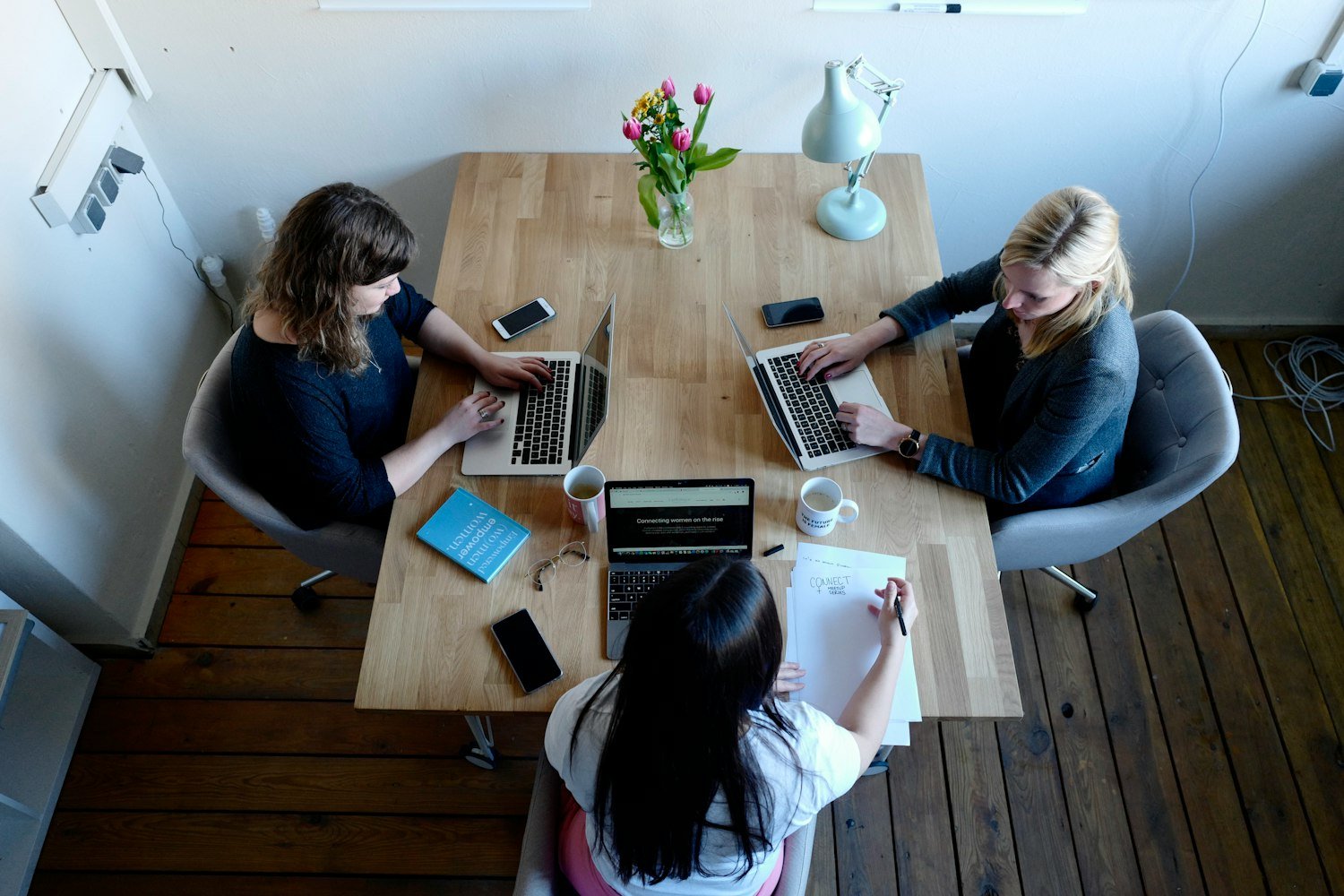 Members meeting around a table to plan, as an Auxiliary unit does at its monthly meetings