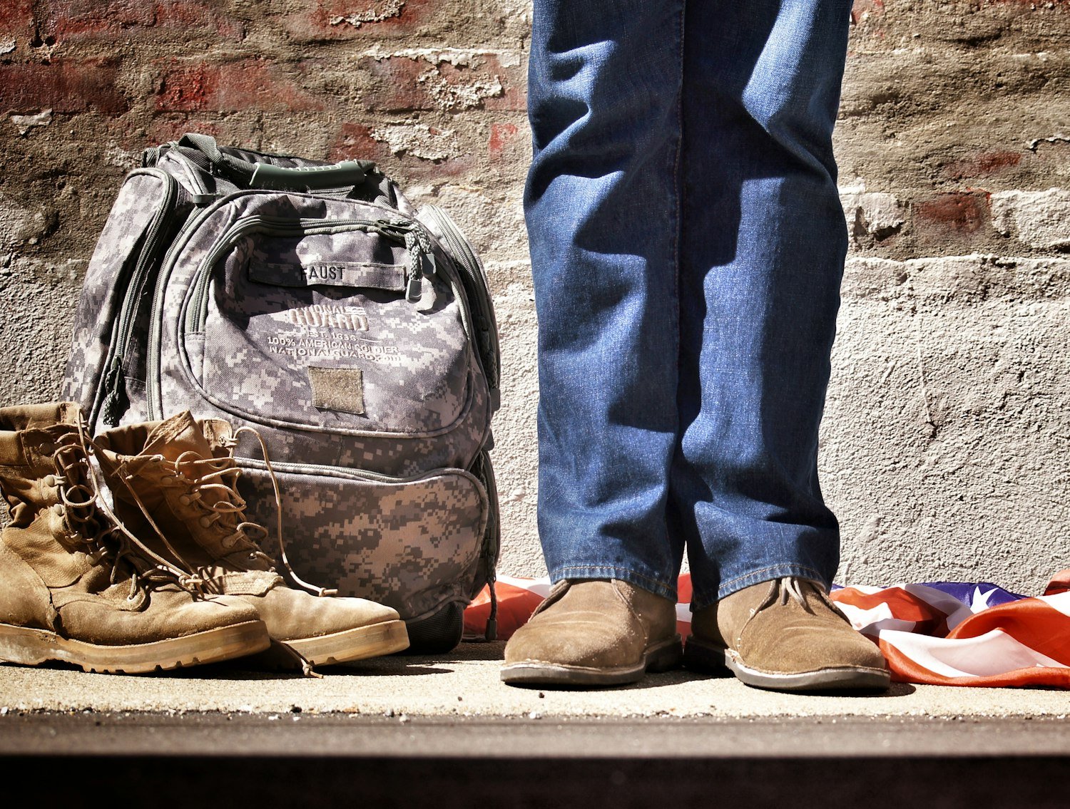A backpack and boots, representing departure for a period of military duty