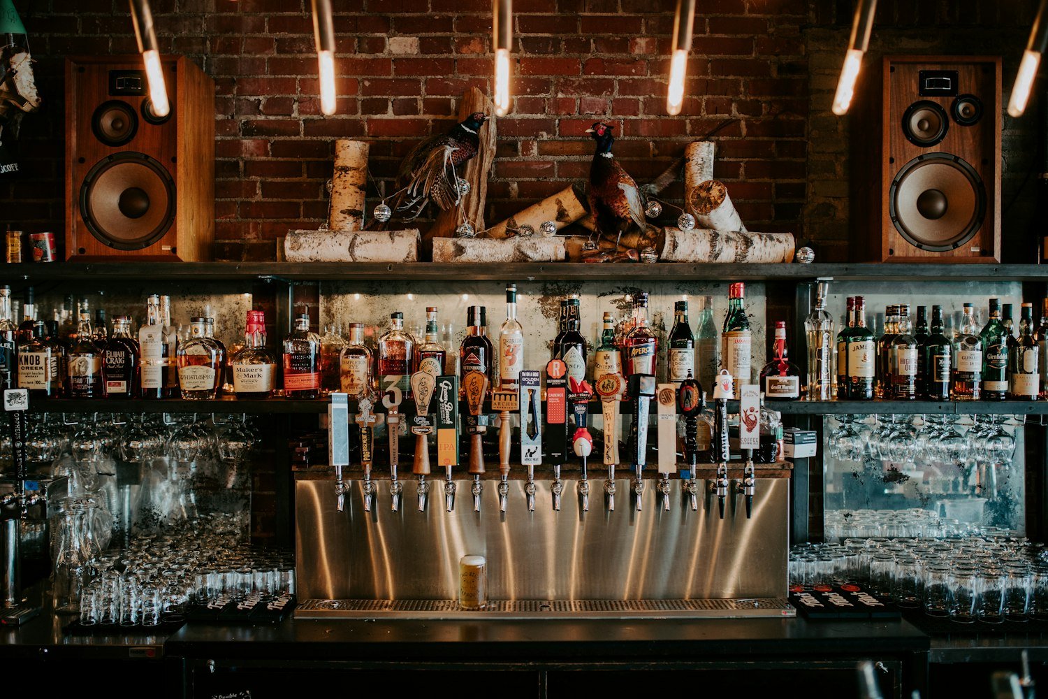A bar counter with bottles, similar to a Legion post canteen bar