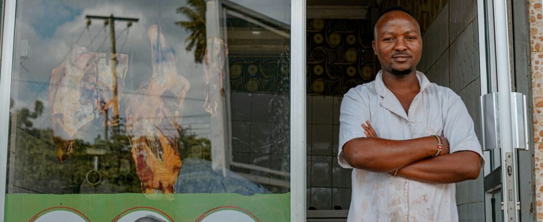 A small business owner standing outside their storefront