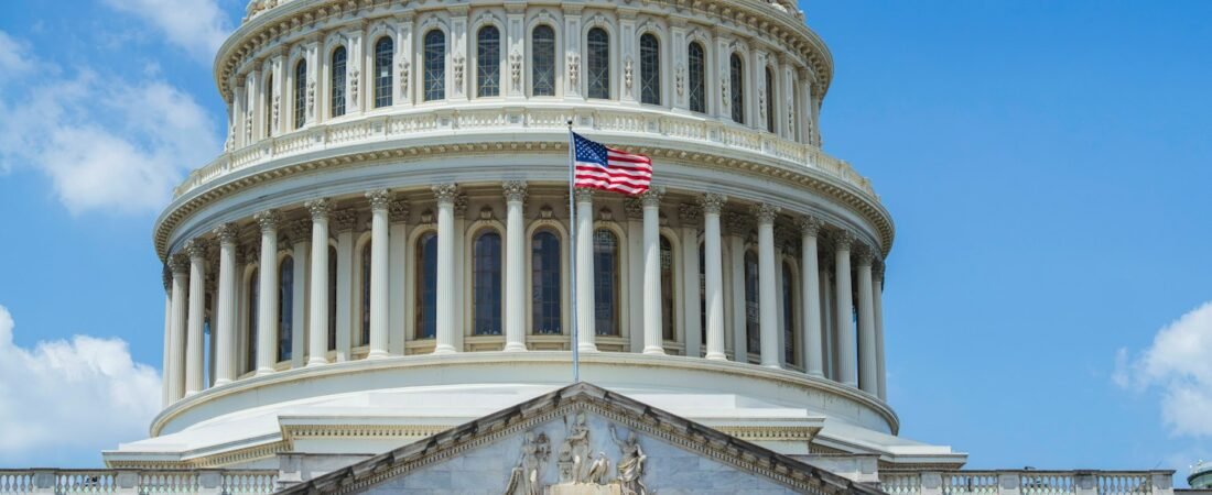 The United States Capitol dome with an American flag, representing federal government employment