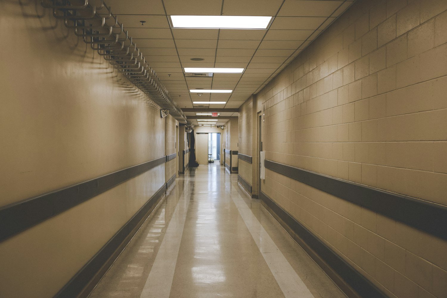 A quiet care facility hallway, representing assisted living and nursing home care