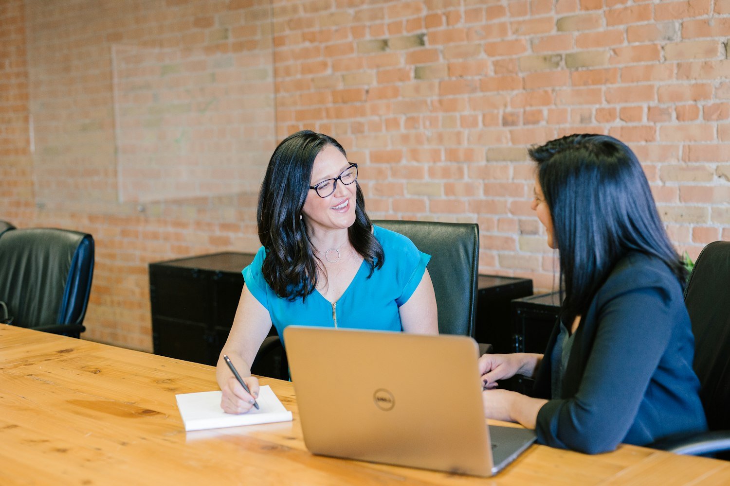 Two people in a career counseling session, as with a VR&E vocational rehabilitation counselor