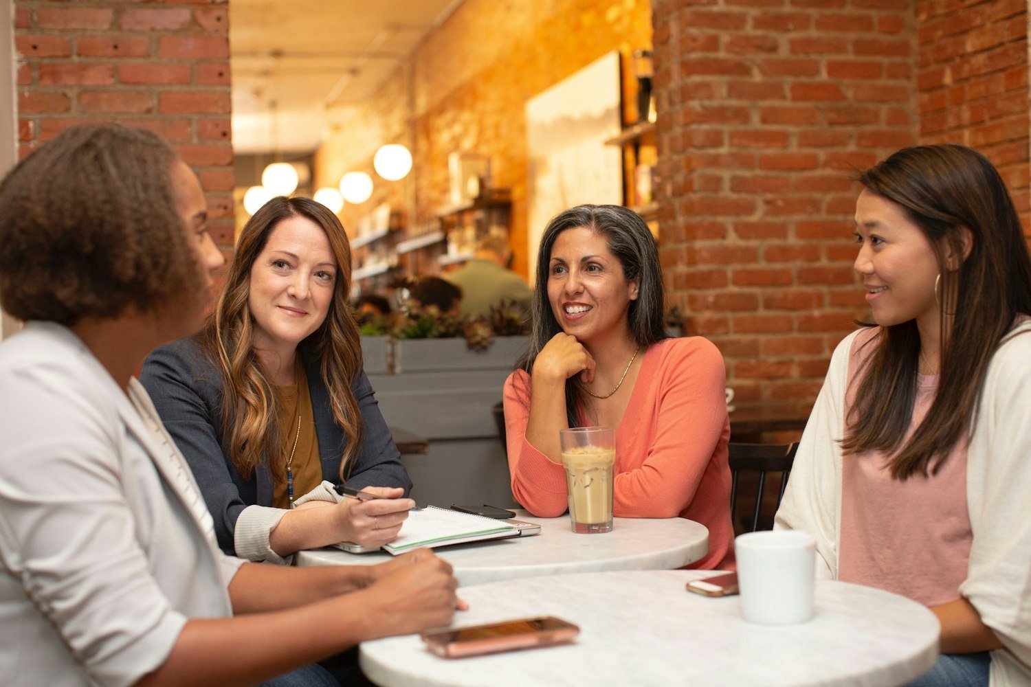 People talking together at a table, representing caregiver peer support groups