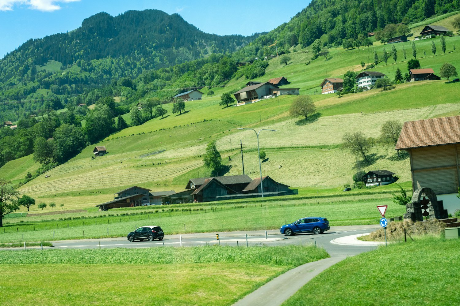 Cars on a road through green hills, the kind of drive rural veterans make for care