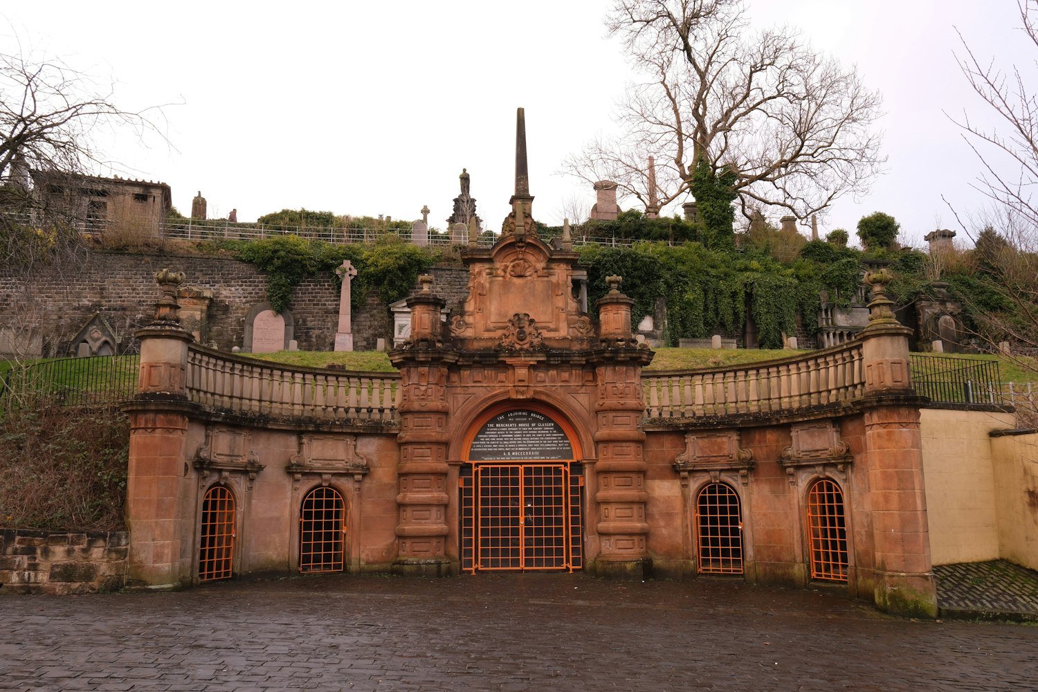An ornate entrance gate leading into a cemetery