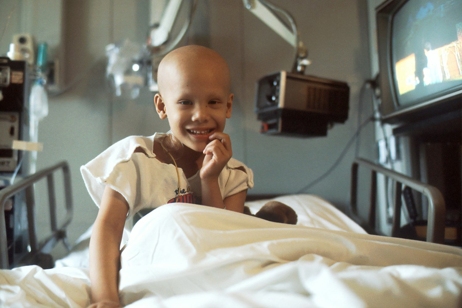 A child sitting on a hospital bed, representing the children supported by the American Legion Child Welfare Foundation