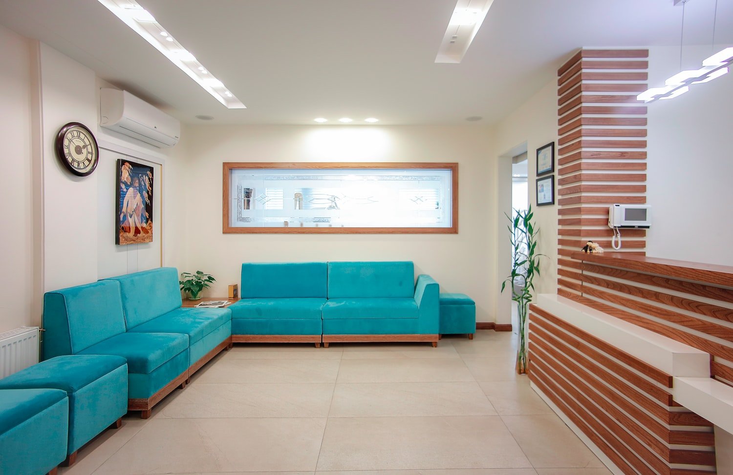 A clinic waiting area with a couch and plant, where veterans wait before an exam