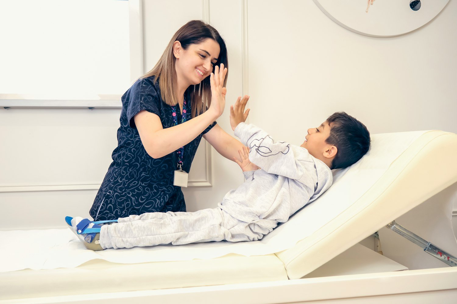A clinician giving a child a high five after an appointment