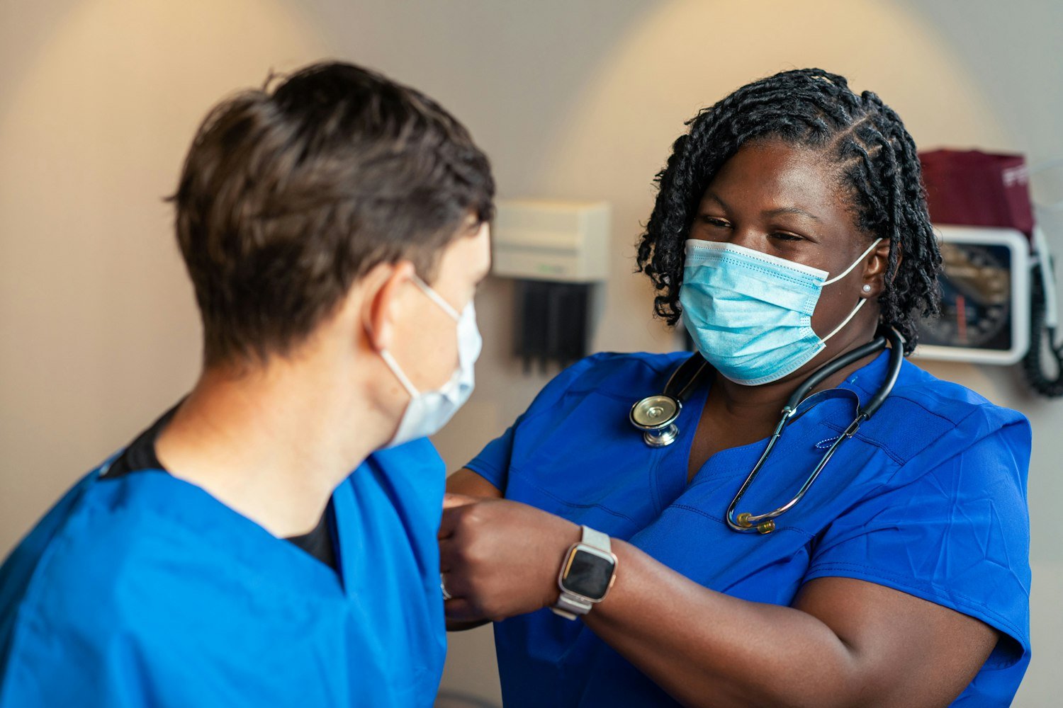 Clinicians in scrubs during a medical examination, as at a VA compensation exam
