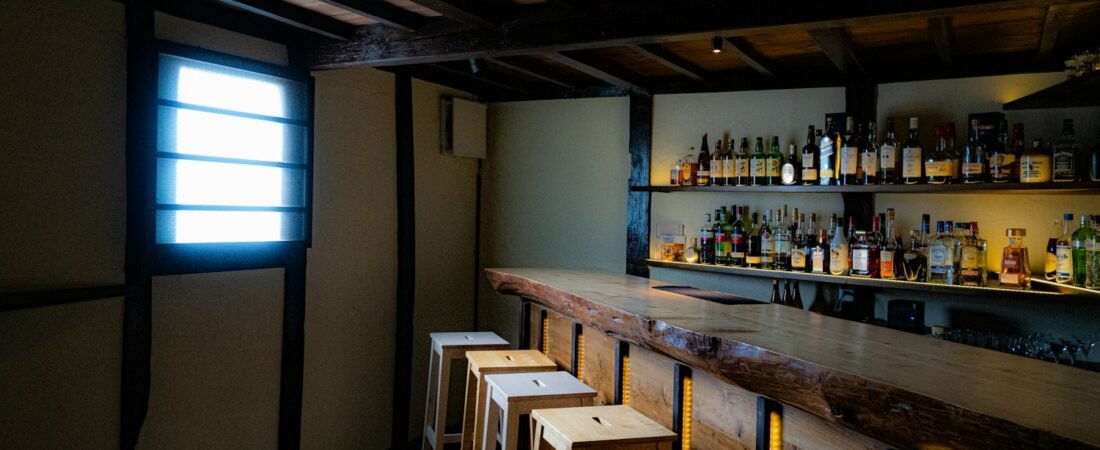A rustic bar interior with stools, similar in feel to a Legion post canteen