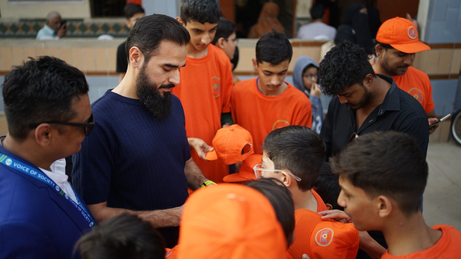 A volunteer handing out items to children during a community outreach effort