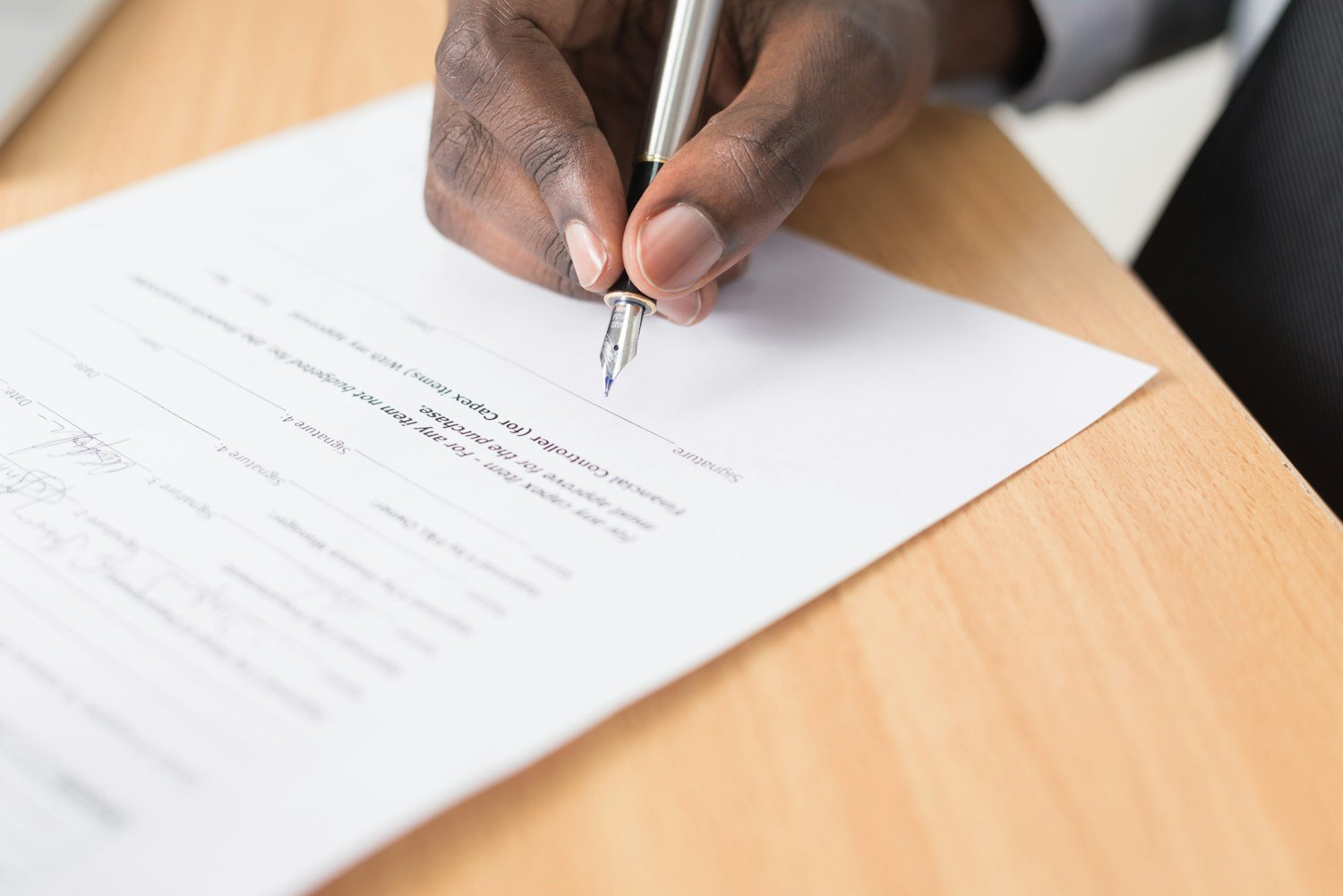 A person writing on paperwork, as when completing VA Form 21-686c