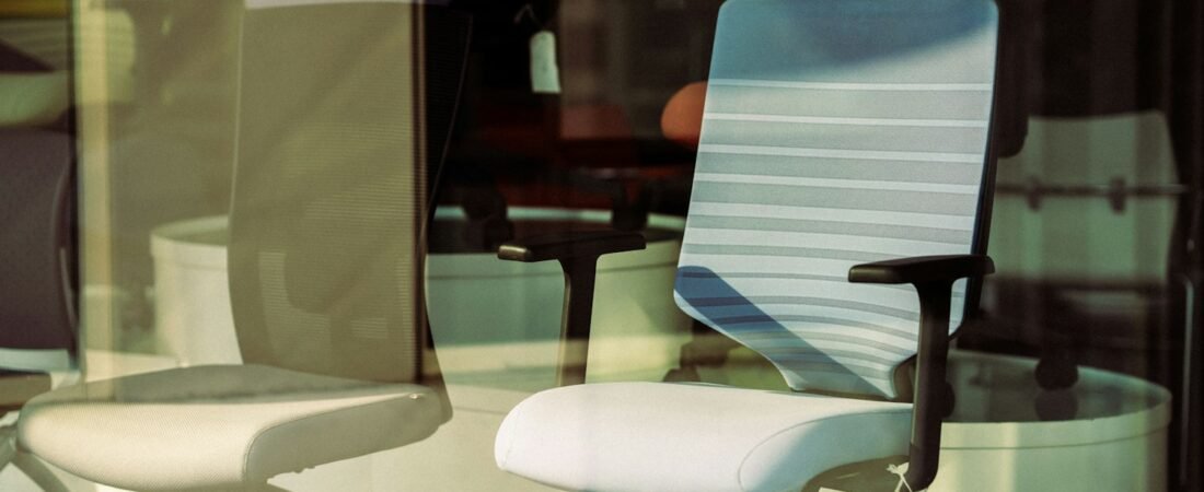 An empty office chair in front of a window, representing a job a veteran can no longer hold