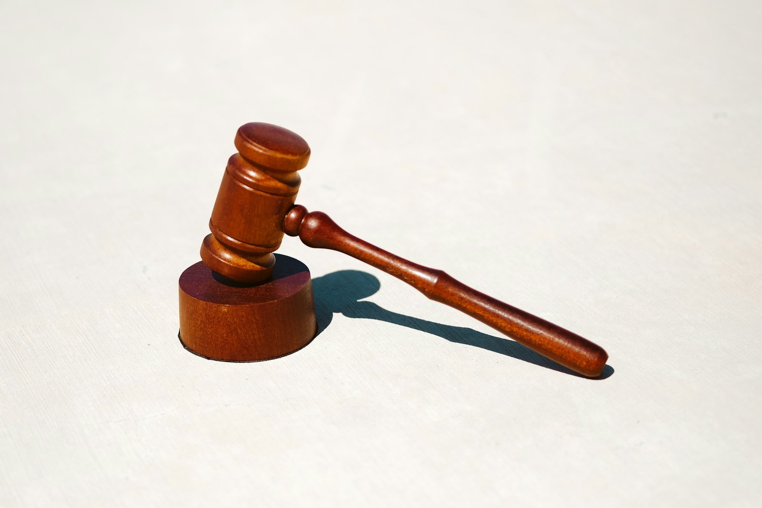 A gavel resting on a white surface, symbolizing parliamentary procedure at meetings