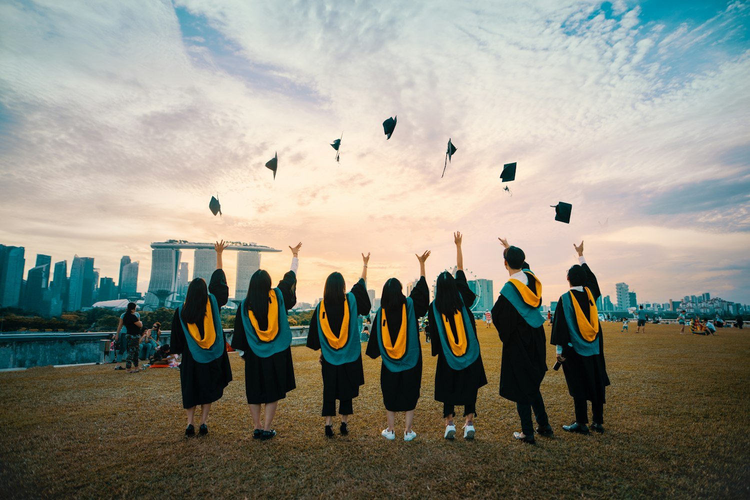 Graduates throwing caps in the air, representing the high school students selected for Girls State