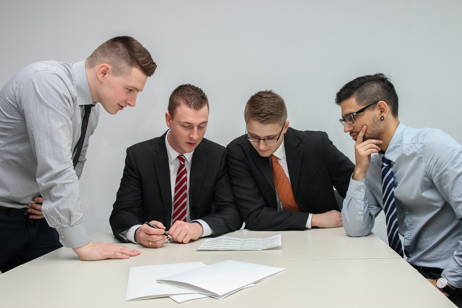 A group of people reviewing documents together around a table