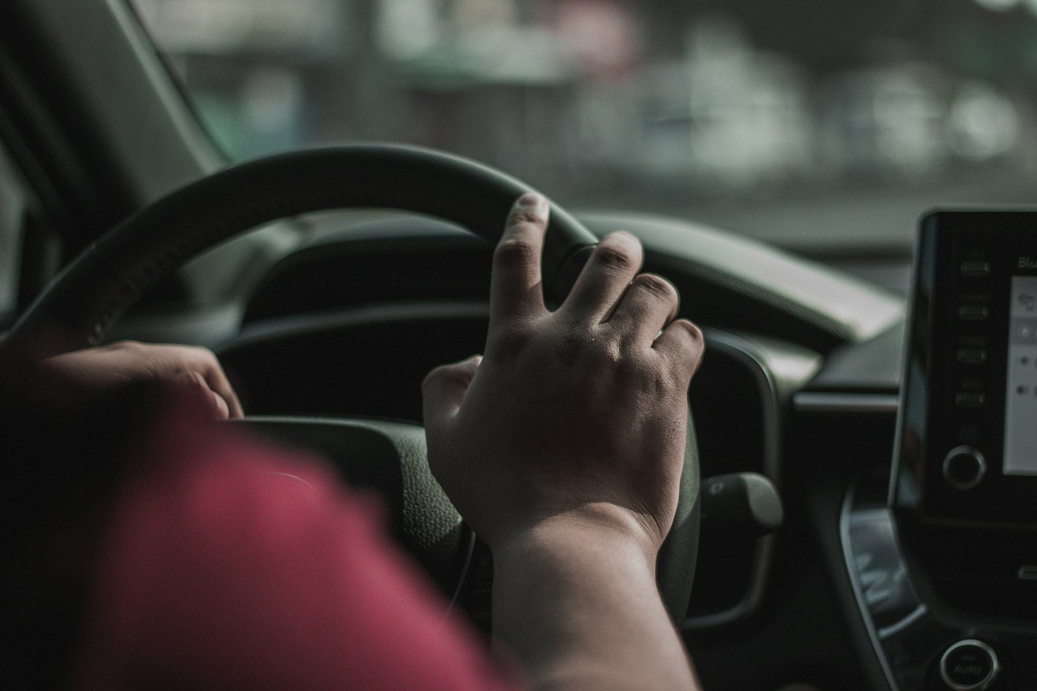 A hand on a steering wheel while driving, the trip to and from a VA appointment