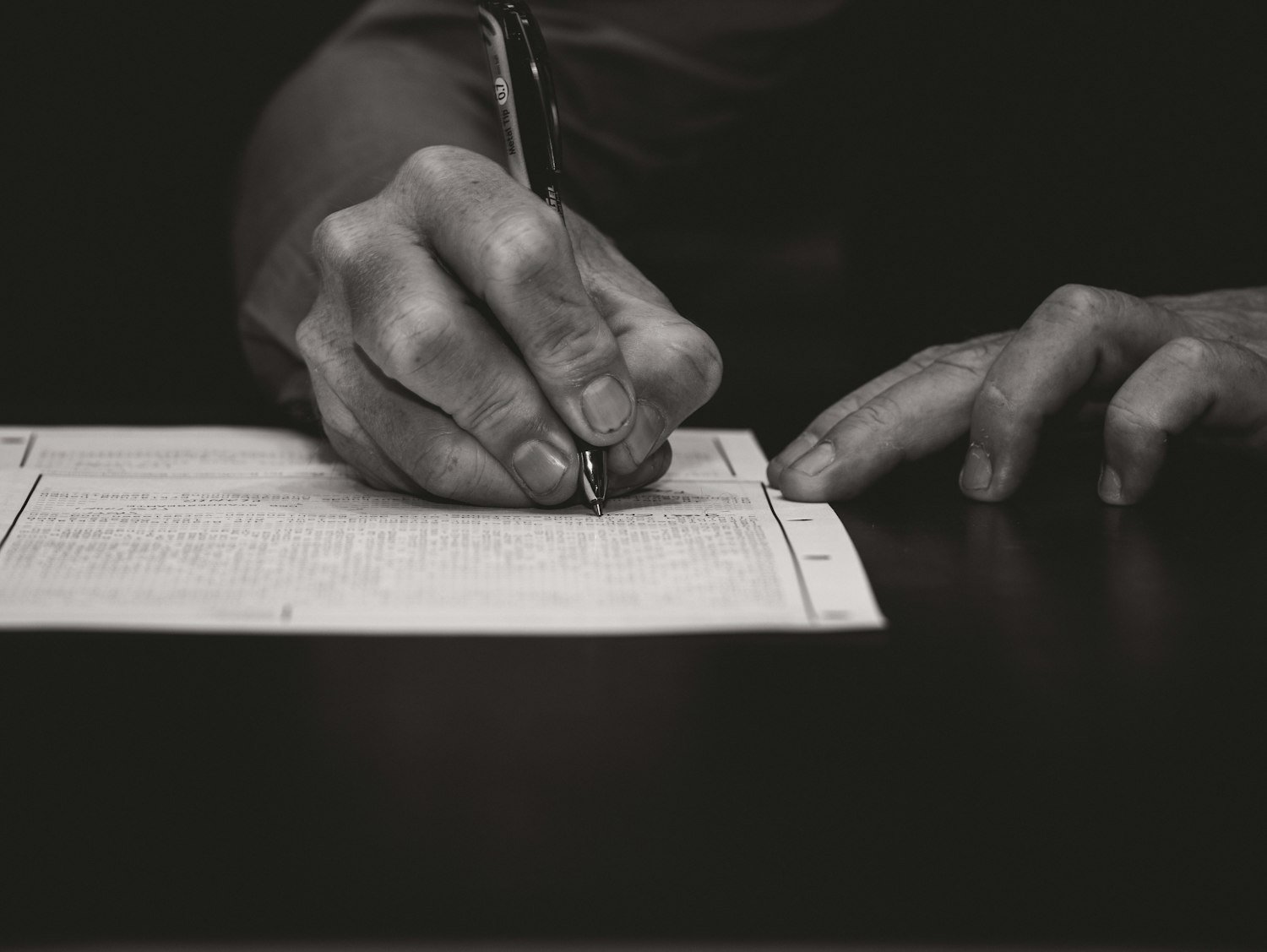 A hand writing with a fountain pen, as when drafting a personal statement for a board