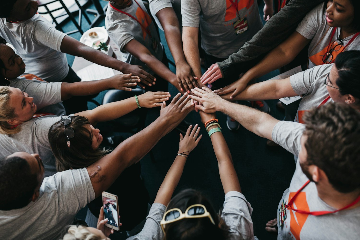People placing their hands together in the middle, representing comradeship among squadron members