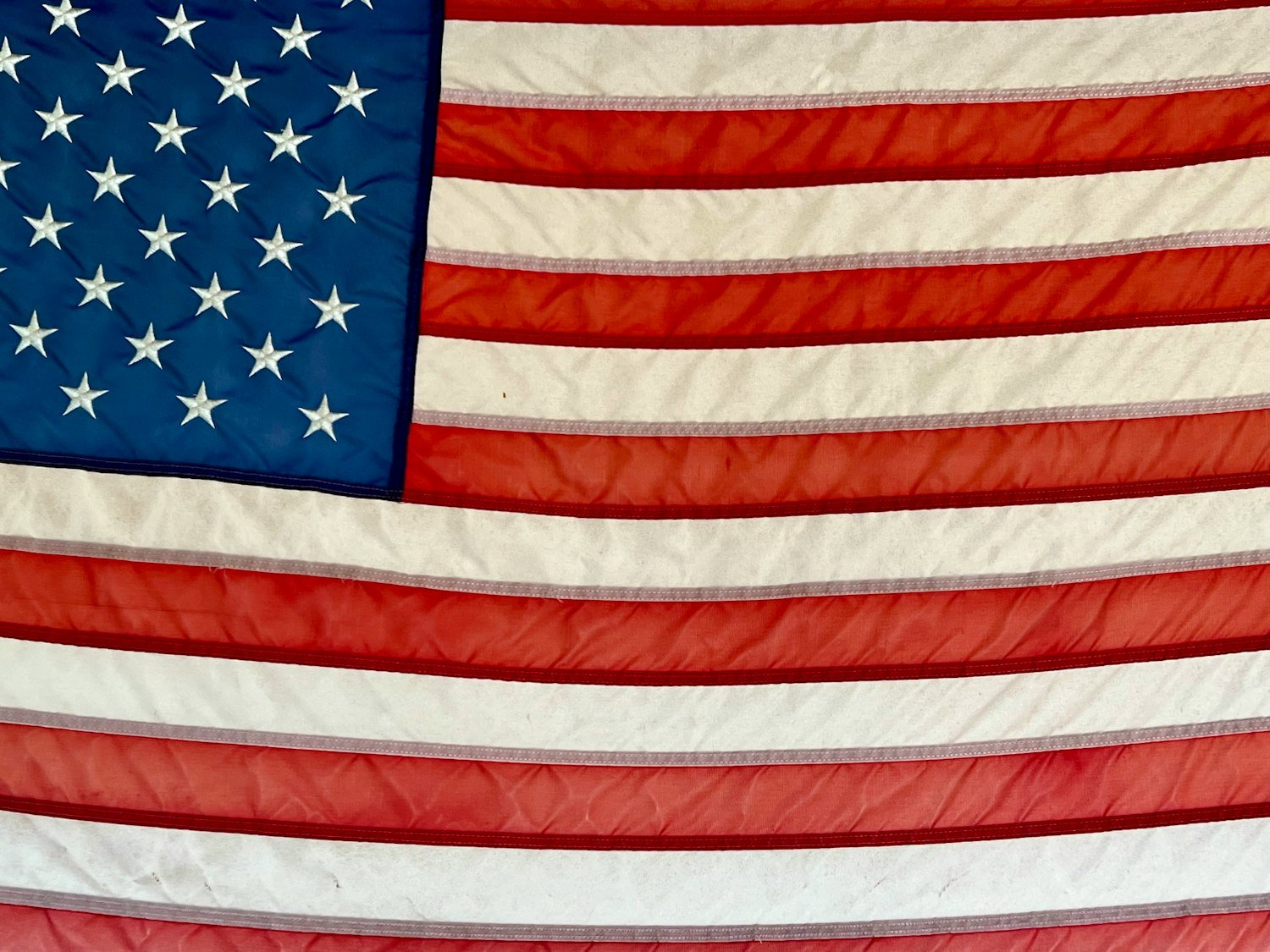 A historic American flag with stars, representing the era of the Legion's founding