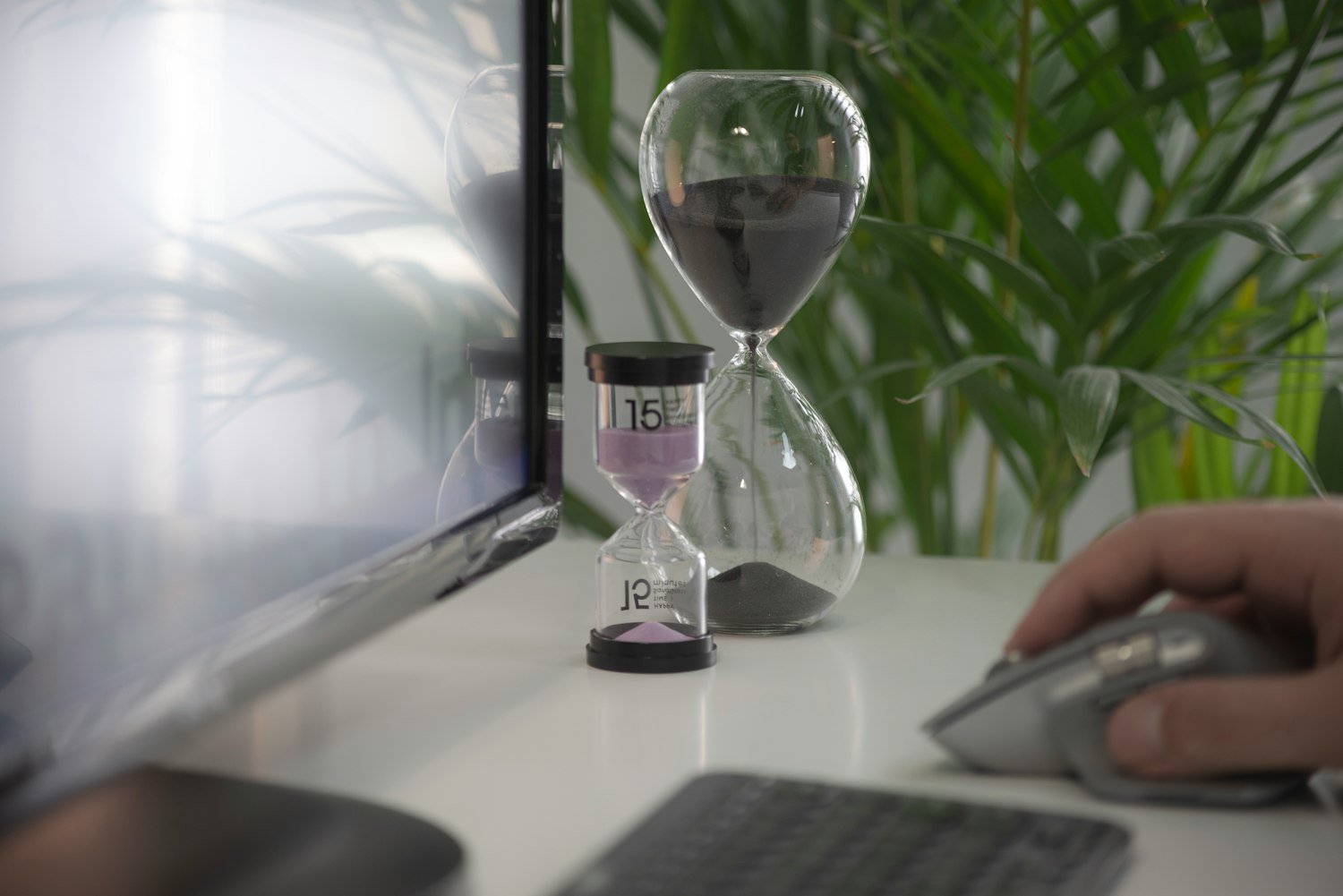 An hourglass on a white table, representing the one-year window closing