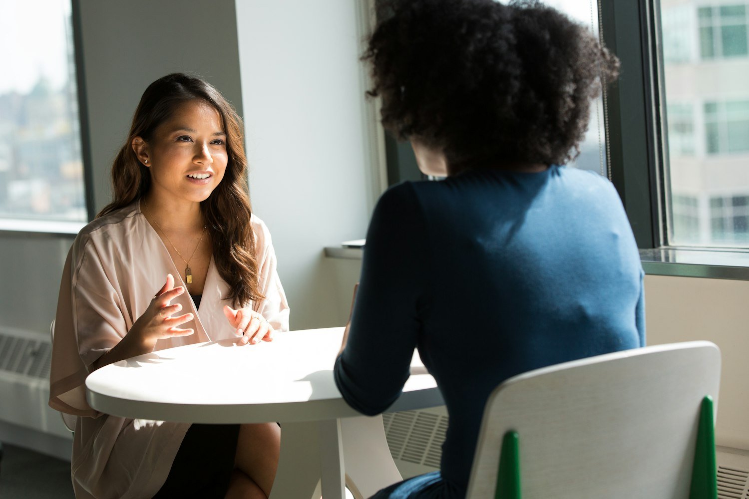 Two people seated for a job interview, the stage that follows making the certificate