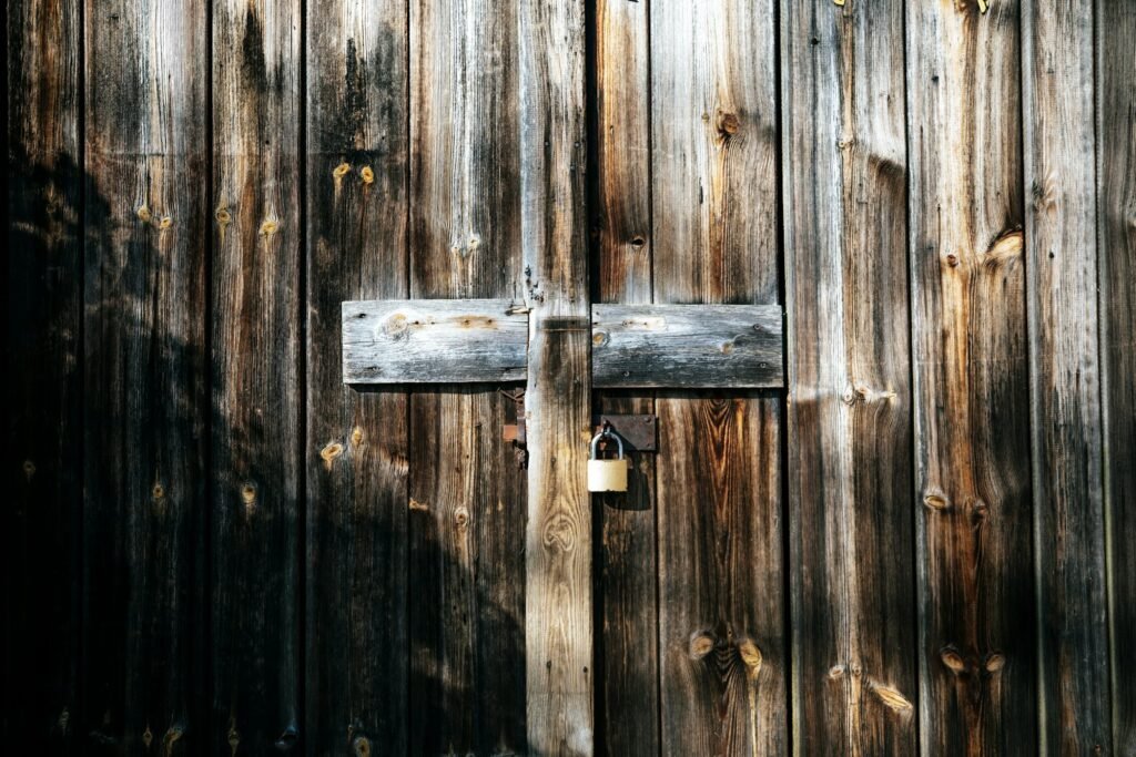 A key in the lock of a weathered wooden door