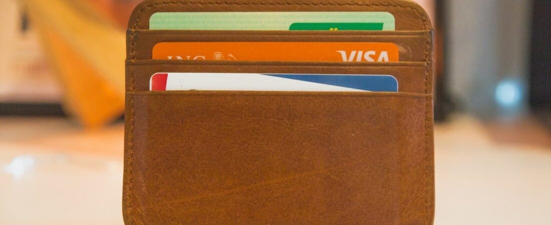 A leather wallet holding identification cards