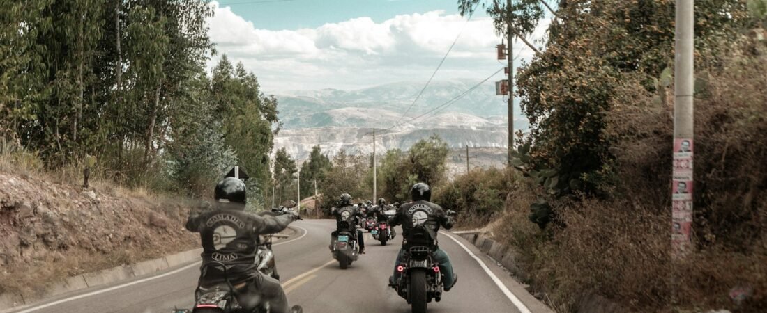 A group of riders traveling together down a road, similar to an American Legion Riders group ride