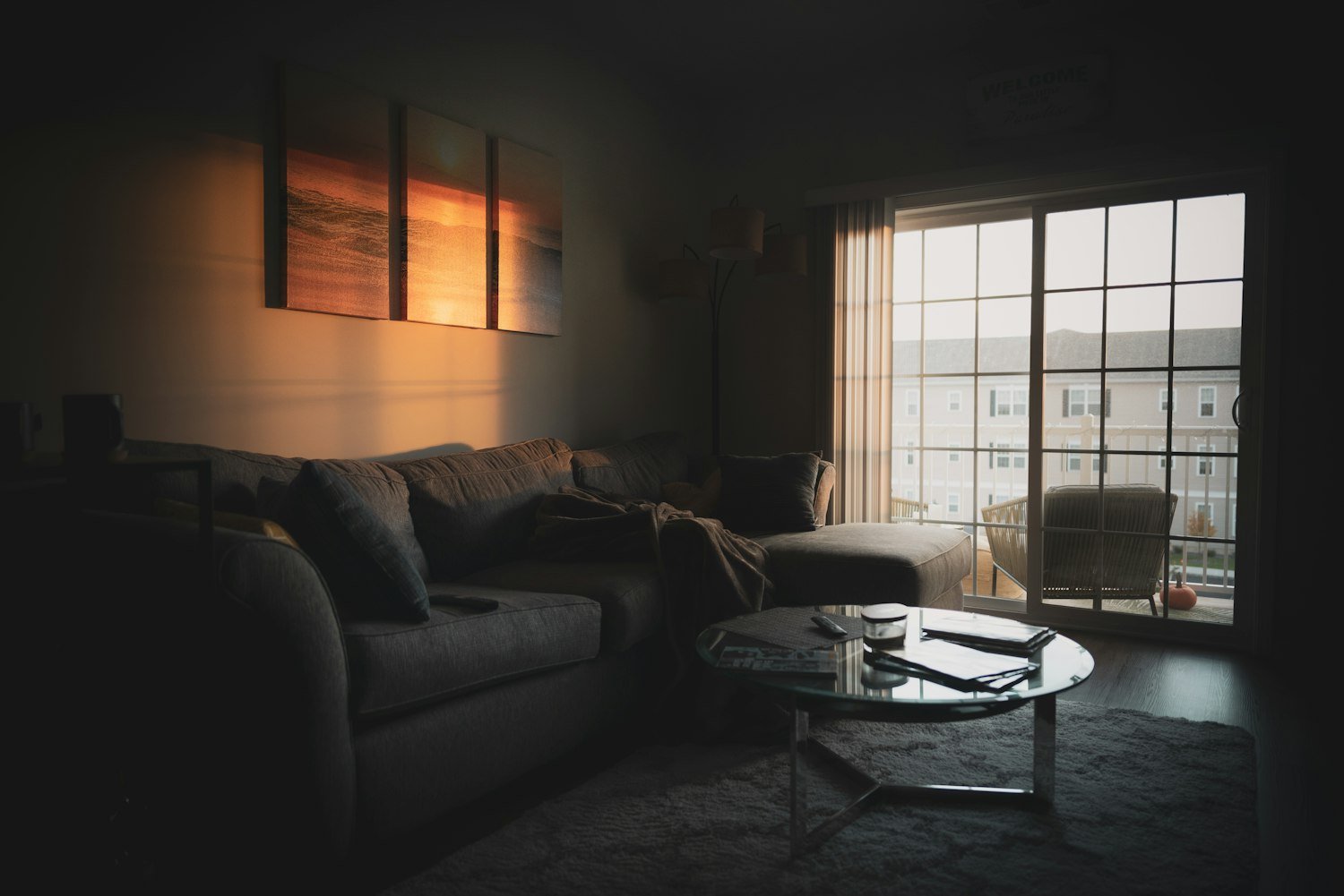 A sofa near a window with daylight coming in, a quiet home setting