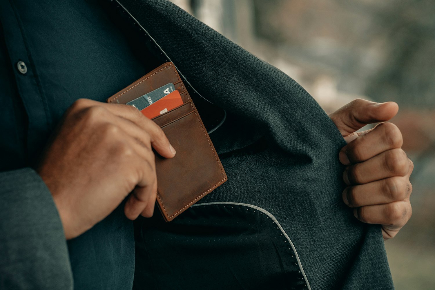 A person retrieving a wallet from a pocket