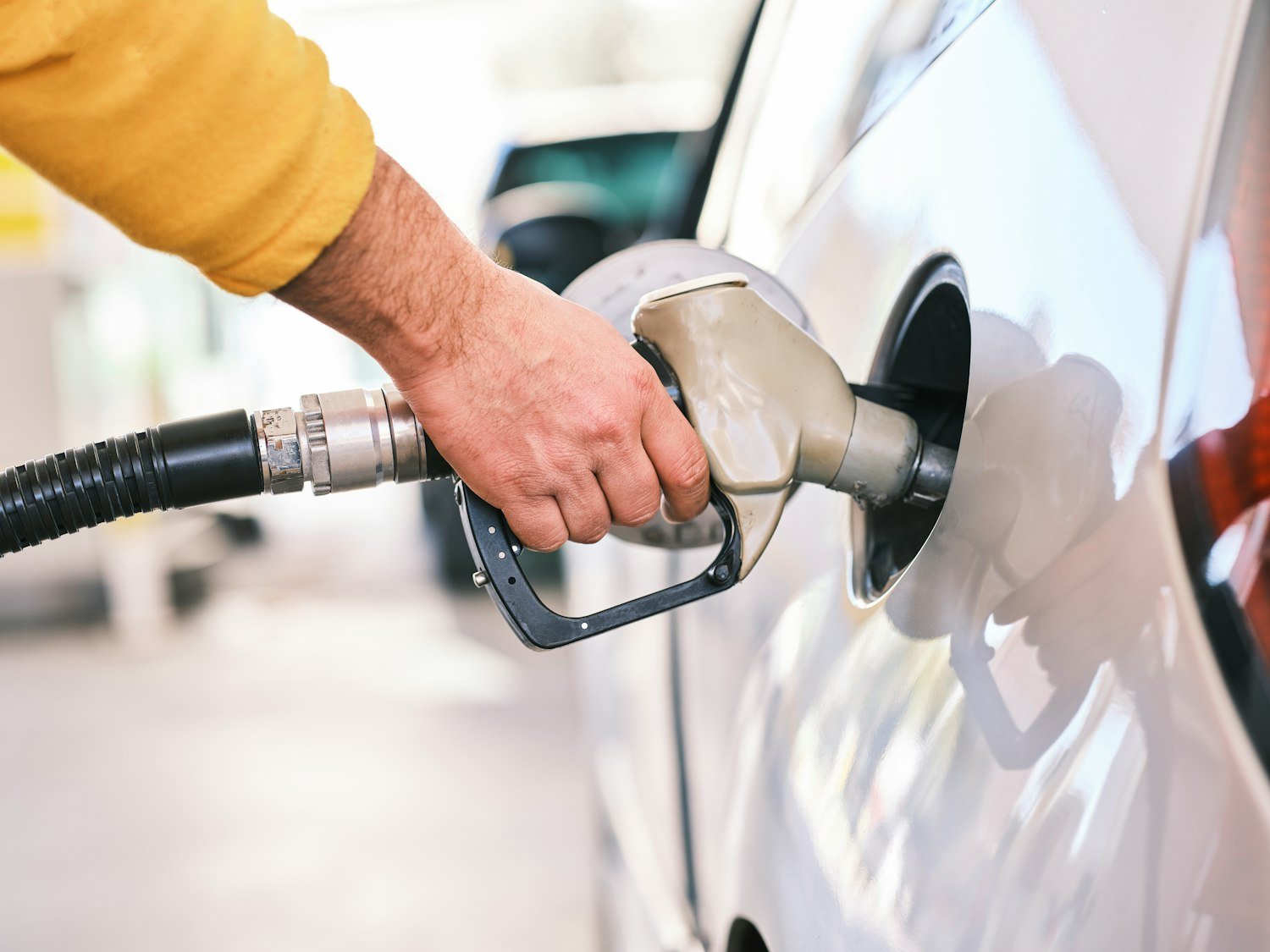 A man pumping gas into his car, the out-of-pocket cost of driving to a VA appointment