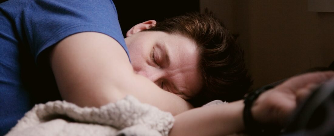 A man asleep in bed, representing the disrupted rest sleep apnea causes