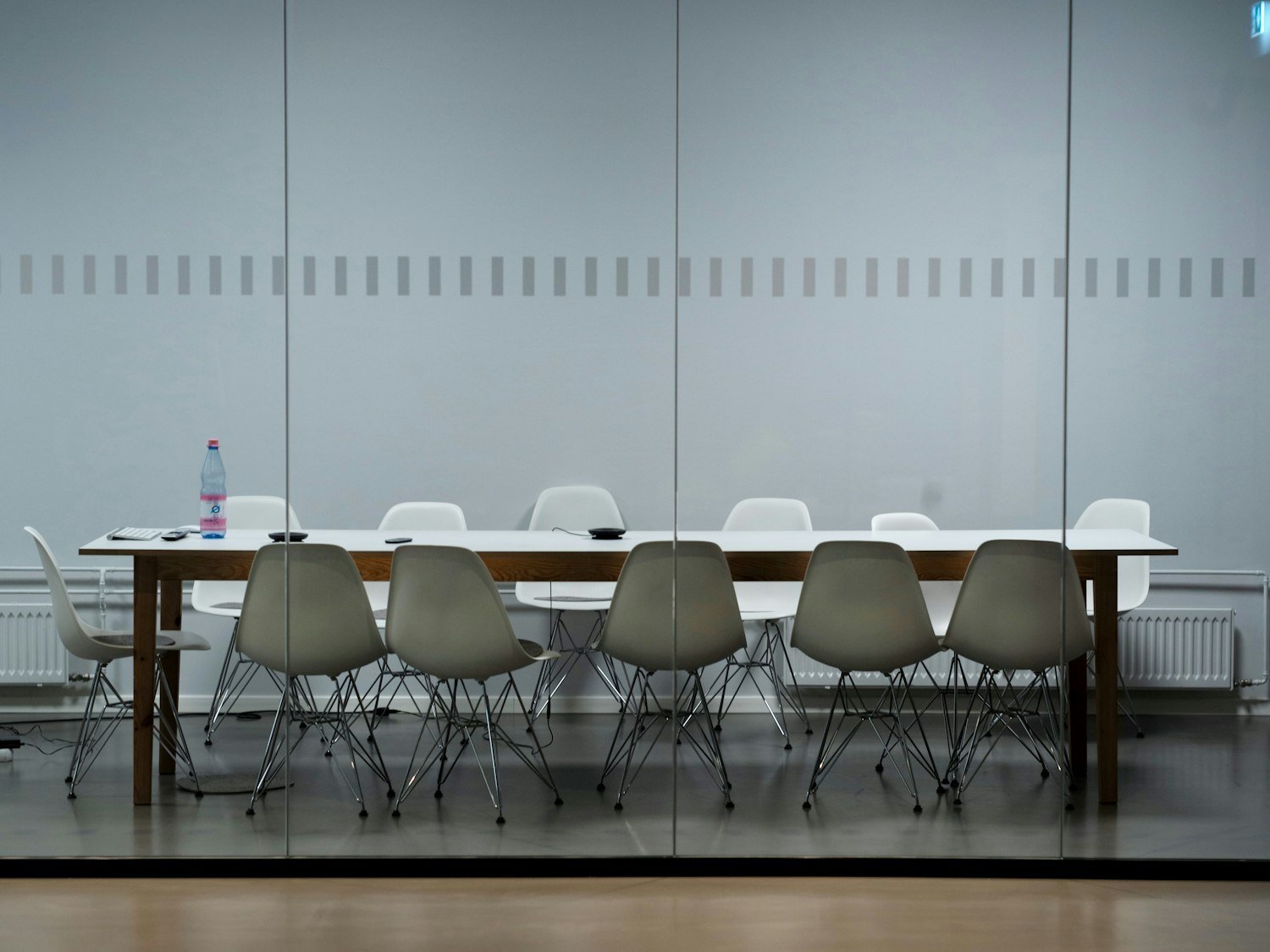 A long meeting room table surrounded by chairs, like a Legion post meeting room