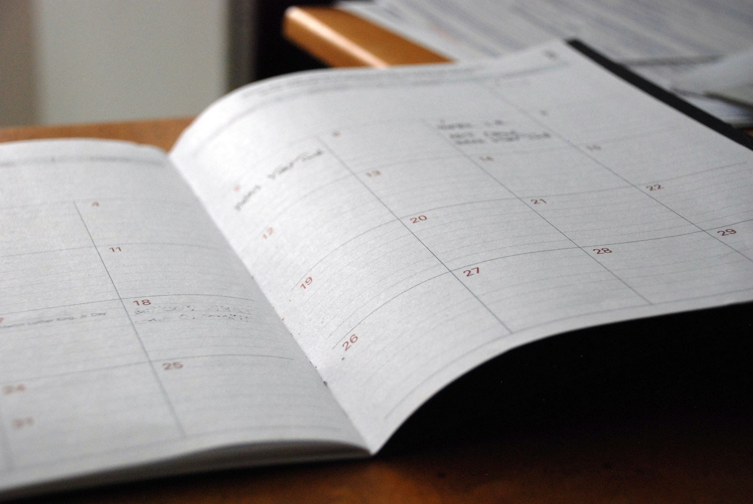 An open monthly planner on a desk, for tracking separation and enrollment dates