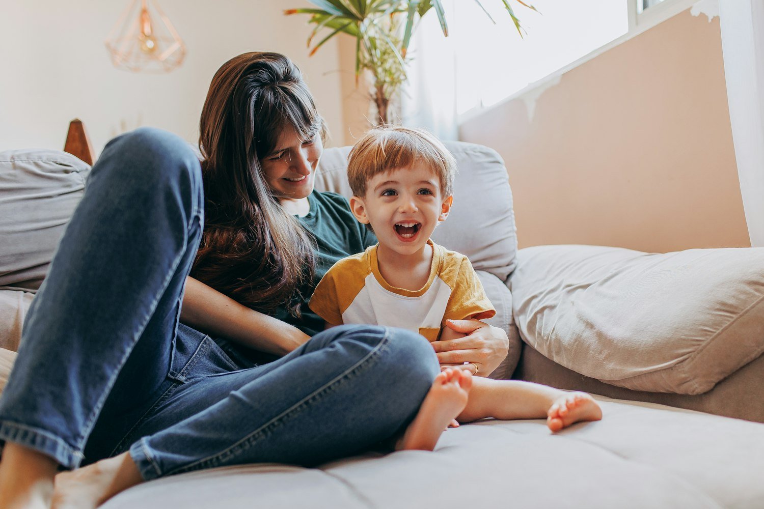 A woman and child sitting together at home, reflecting the family responsibilities many women veterans balance