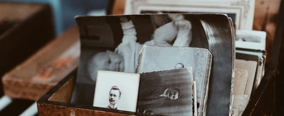 Old family photographs stored in a wooden chest, the usual starting point for military genealogy