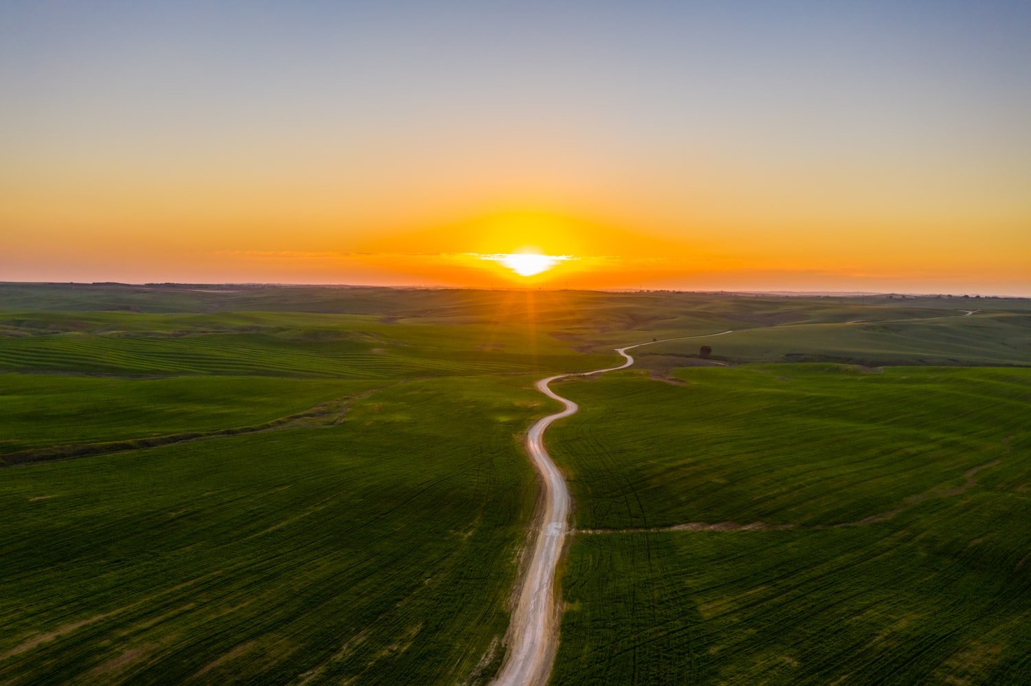 An open grass field at sunset, representing stability and a new beginning