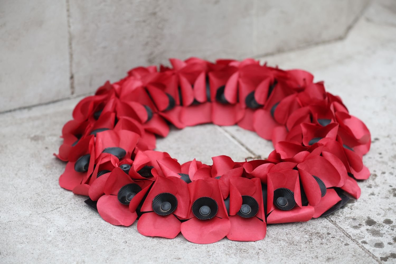 A red paper poppy wreath used for remembrance and memorial ceremonies