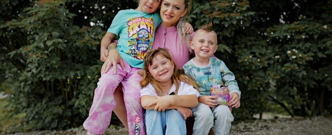 A parent with three children outdoors, the family members VA compensation can include