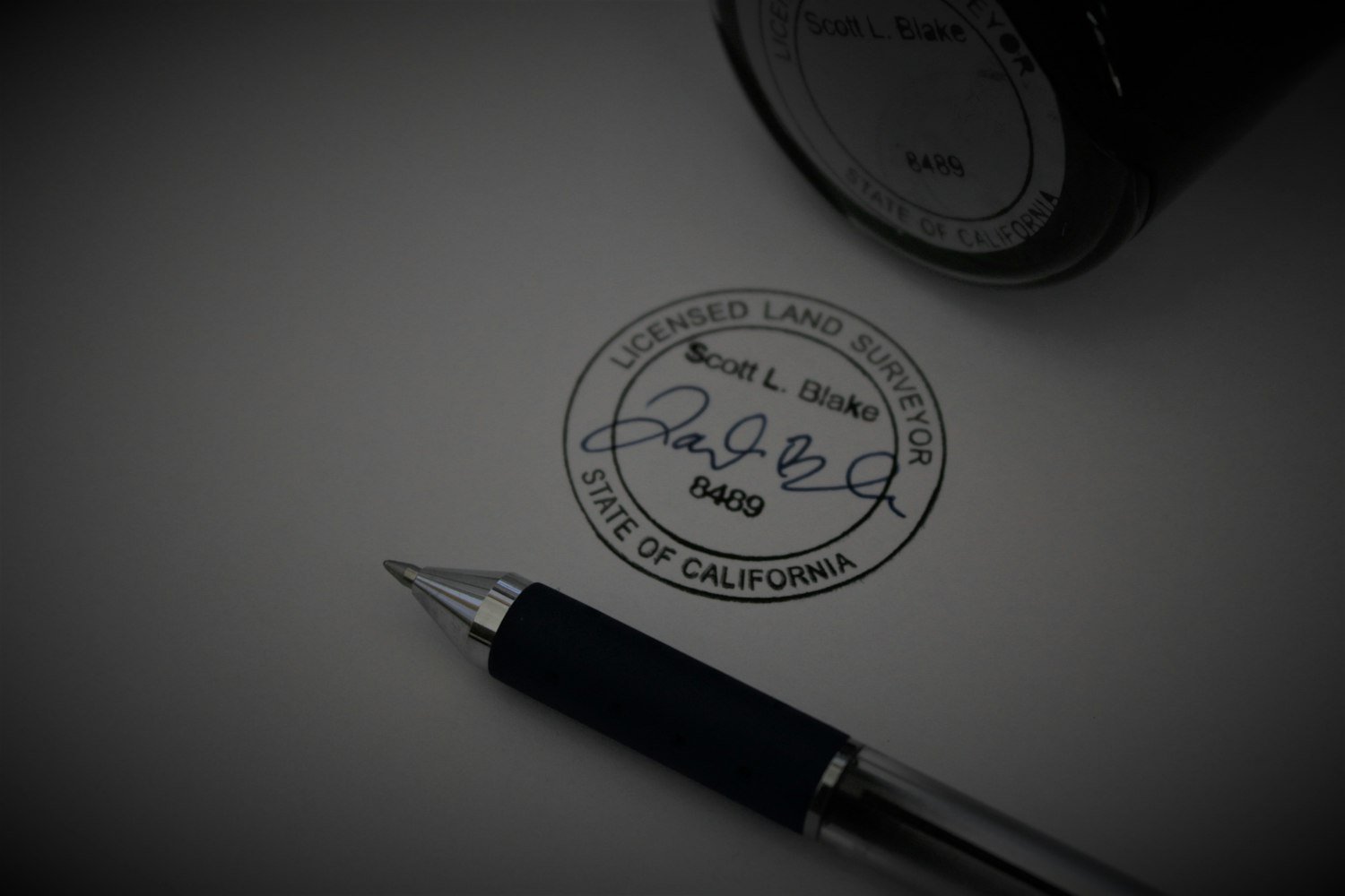 A pen resting on a form, as when completing and signing an SF-180 request