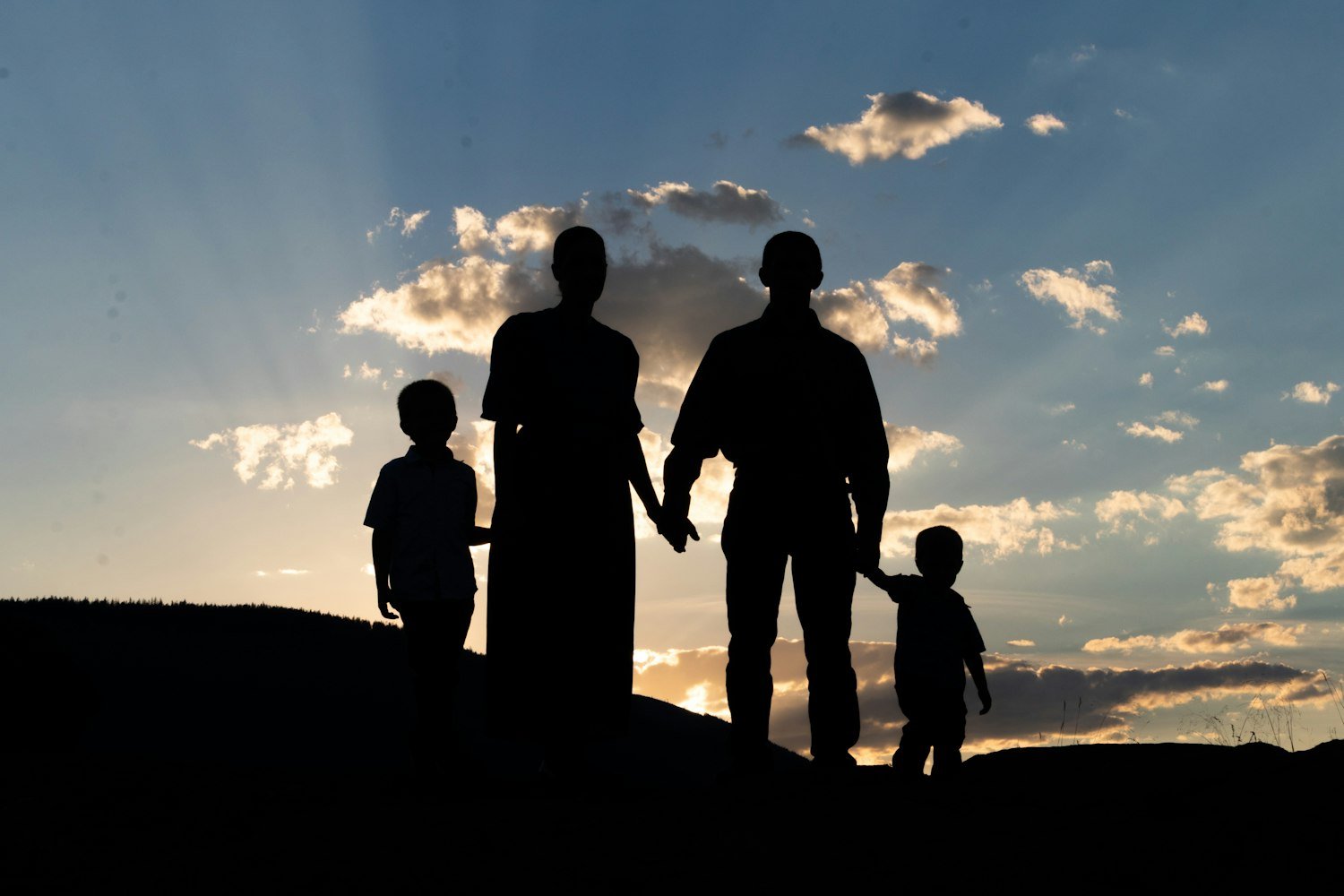 People standing on a hill looking at the sunset, representing planning for the future