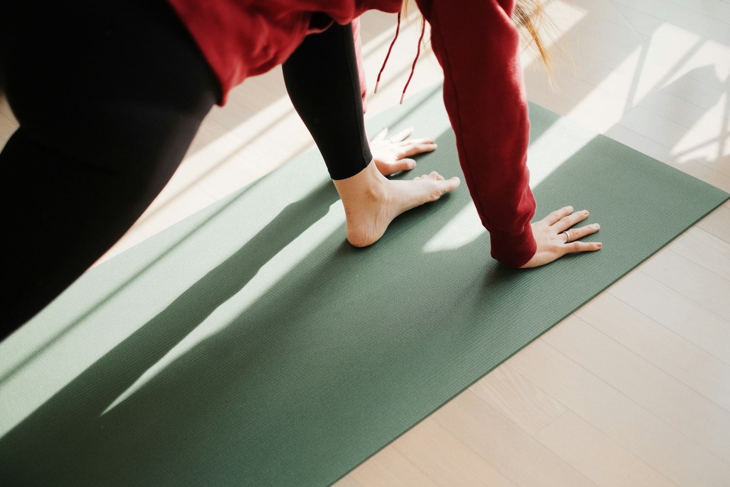 A person standing on a mat, as in a physical therapy session for back treatment